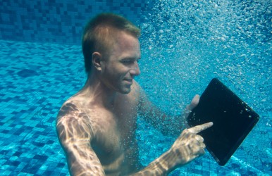 Man Underwater with a Tablet Computer