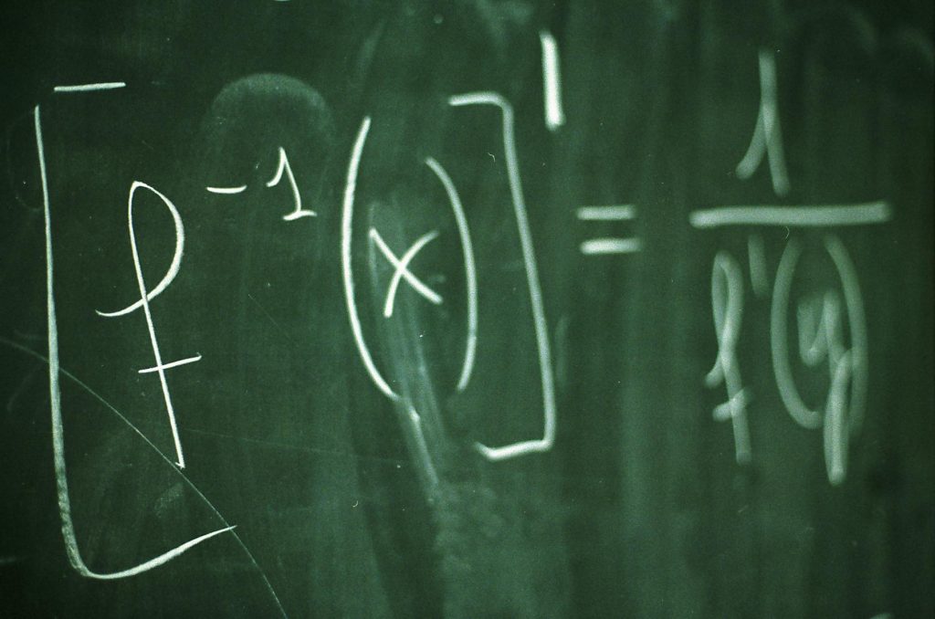 Equation in white chalk on a chalkboard