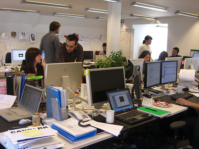 Office space in London with workers at desks in shared workspace